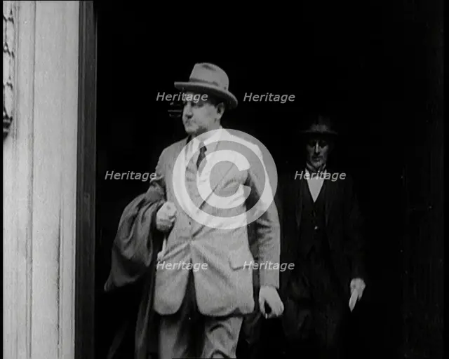 Two Male Civilians Emerging from a Building, 1924. Creator: British Pathe Ltd.