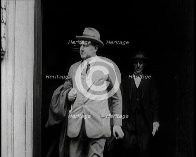 Two Male Civilians Emerging from a Building, 1924. Creator: British Pathe Ltd.
