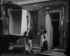 Two Male Civilians Load Furniture Into a Van Outside of 10 Downing Street, 1924. Creator: British Pathe Ltd