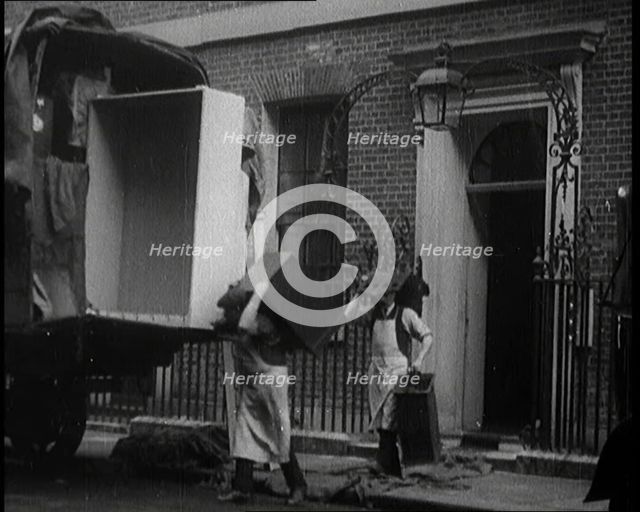 Two Male Civilians Load Furniture Into a Van Outside of 10 Downing Street, 1924. Creator: British Pathe Ltd.