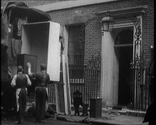 Two Male Civilians Load Furniture Into a Van Outside of 10 Downing Street, 1924. Creator: British Pathe Ltd