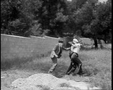 Two Male American Civilians Covering Their Faces with Handkerchiefs Carrying a Male American...1930. Creator: British Pathe Ltd