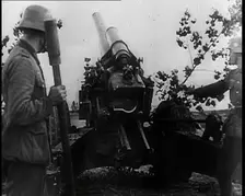 Two Male German Soldiers by an Artillery Gun, 1939. Creator: British Pathe Ltd