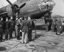 Two Male Officers Talking to a Group of Pilots in front of a Bomber Aircraft, 1943-1944. Creator: British Pathe Ltd
