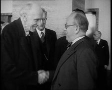 Two Male League of Nations Delegates Greeting Each Other By Shaking Hands While Two Other..., 1937. Creator: British Pathe Ltd