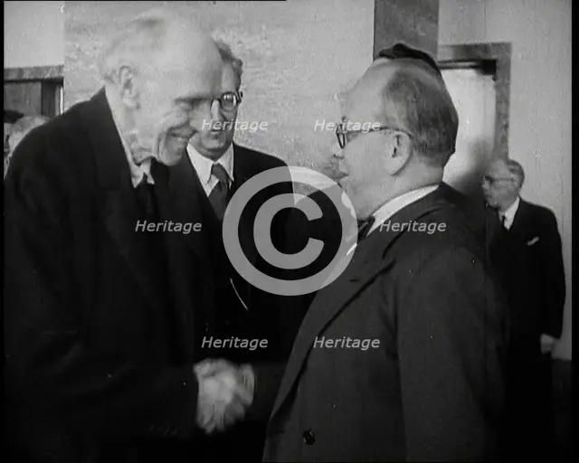 Two Male League of Nations Delegates Greeting Each Other By Shaking Hands While Two Other..., 1937. Creator: British Pathe Ltd.