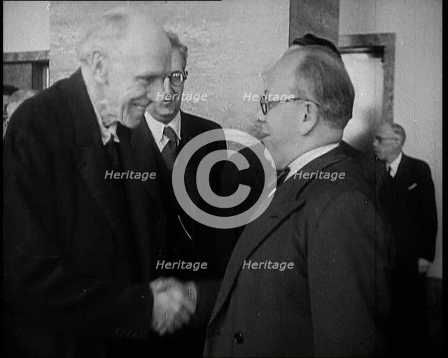 Two Male League of Nations Delegates Greeting Each Other By Shaking Hands While Two Other..., 1937. Creator: British Pathe Ltd.