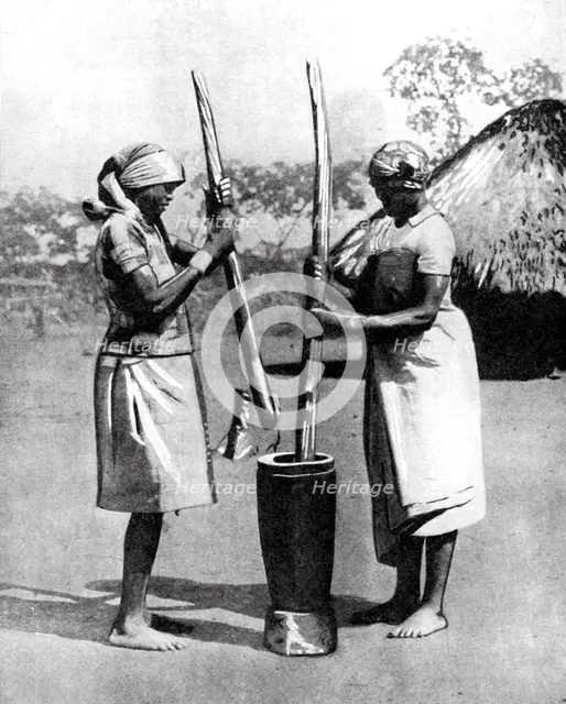 Two Mashona tribeswomen pounding maize and millet, Zimbabwe, Africa, 1936.Artist: Wide World Photos