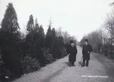 Two men walking in the Castle Park, Landskrona, Sweden, 1900. Creator: Borg Mesch