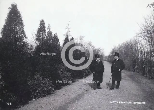 Two men walking in the Castle Park, Landskrona, Sweden, 1900.  Creator: Borg Mesch.
