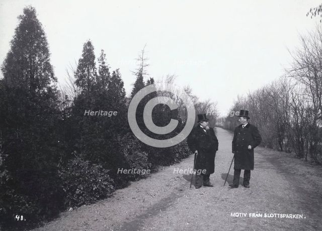 Two men walking in the Castle Park, Landskrona, Sweden, 1900.  Creator: Borg Mesch.