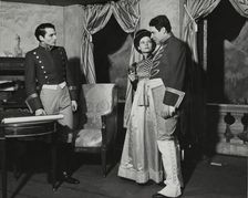 Two men and a woman, standing, 1938. Creator: Unknown