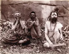 Two men and a boy sitting cross-legged on the ground surrounded by leaves; their faces... 1896/1897 Creator: Unknown