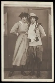 Two men, both in drag, pose wearing hats and make-up, c1918. Creator: Unknown