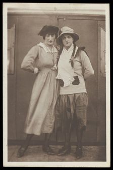 Two men, both in drag, pose wearing hats and make-up, c1918. Creator: Unknown