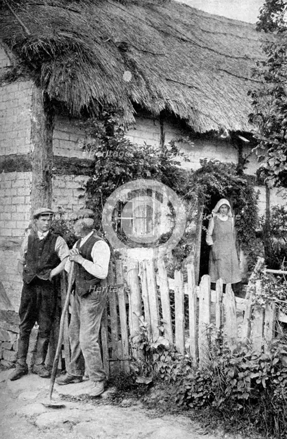 Two men chatting outside a cottage, near Lucton, Herefordshire, c1922.Artist: AW Cutler