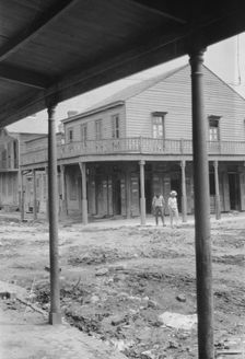 Two men crossing an unpaved street, New Orleans or Charleston, South Carolina, between 1920 and 1926 Creator: Arnold Genthe