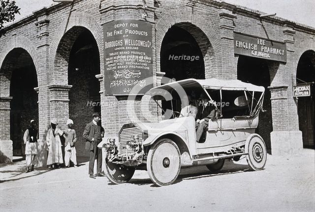 Two men in a car outside the Wellcome pharmaceutical depot in the Middle East, c1900s. Creator: Unknown.