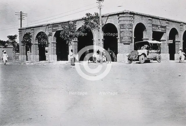 Two men in a car outside the Wellcome pharmaceutical depot in the Middle East, c1910.. Creator: Unknown.