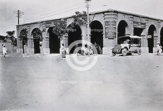 Two men in a car outside the Wellcome pharmaceutical depot in the Middle East, c1910.. Creator: Unknown.