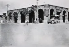 Two men in a car outside the Wellcome pharmaceutical depot in the Middle East, c1910.. Creator: Unknown