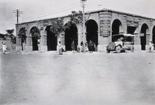 Two men in a car outside the Wellcome pharmaceutical depot in the Middle East, c1910.. Creator: Unknown