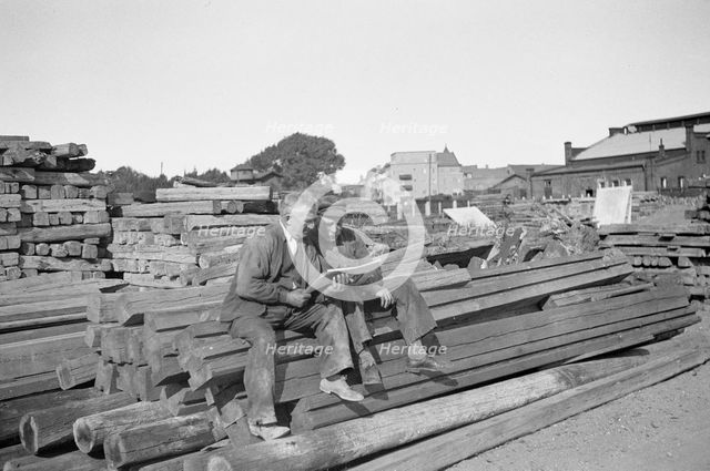 Two men in a woodyard, Landskrona, Sweden, 1935. Creator: Unknown.