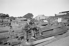 Two men in a woodyard, Landskrona, Sweden, 1935. Creator: Unknown