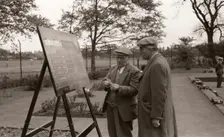 Two men in flat caps look at the bowls scoreboard, York, Yorkshire, 1955