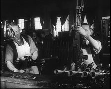 Two Men Making Machine Guns in a Factory, 1940. Creator: British Pathe Ltd