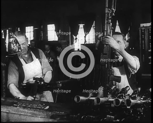Two Men Making Machine Guns in a Factory, 1940. Creator: British Pathe Ltd.