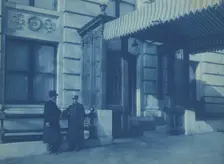 Two men, one a doorman, standing at the F. Street entrance to the Willard..., between 1901 and 1910. Creator: Frances Benjamin Johnston