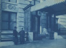 Two men, one a doorman, standing at the F. Street entrance to the Willard..., between 1901 and 1910. Creator: Frances Benjamin Johnston