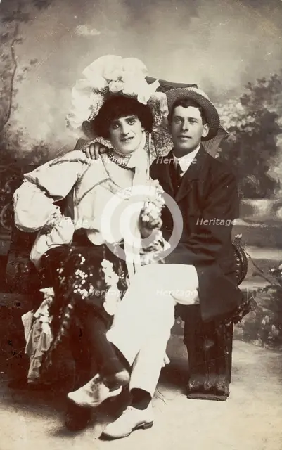 Two men, one in drag, sit together on a bench, (between 1900 and 1901?). Creator: Unknown.