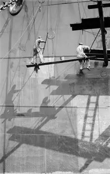 Two men painting a ship in the Royal Albert Dock, Canning Town, London, c1945-c1965. Artist: SW Rawlings
