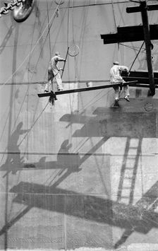 Two men painting a ship in the Royal Albert Dock, Canning Town, London, c1945-c1965. Artist: SW Rawlings