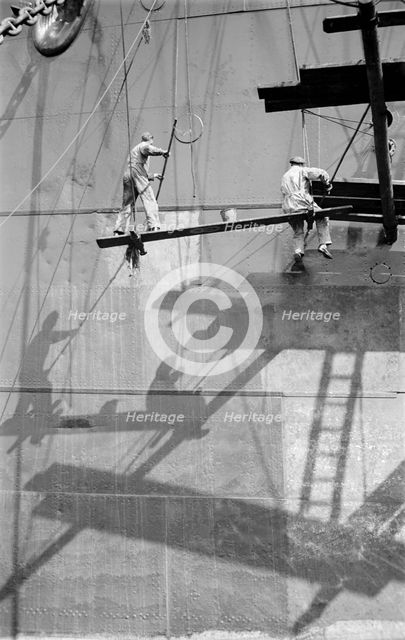 Two men painting a ship in the Royal Albert Dock, Canning Town, London, c1945-c1965. Artist: SW Rawlings