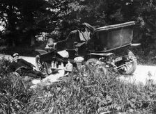 Two men picnicking beside a Vauxhall car, c1906