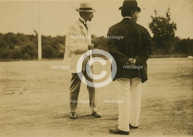 Two men, probably journalists, standing on a field, 1905. Creator: Unknown.
