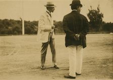 Two men, probably journalists, standing on a field, 1905. Creator: Unknown