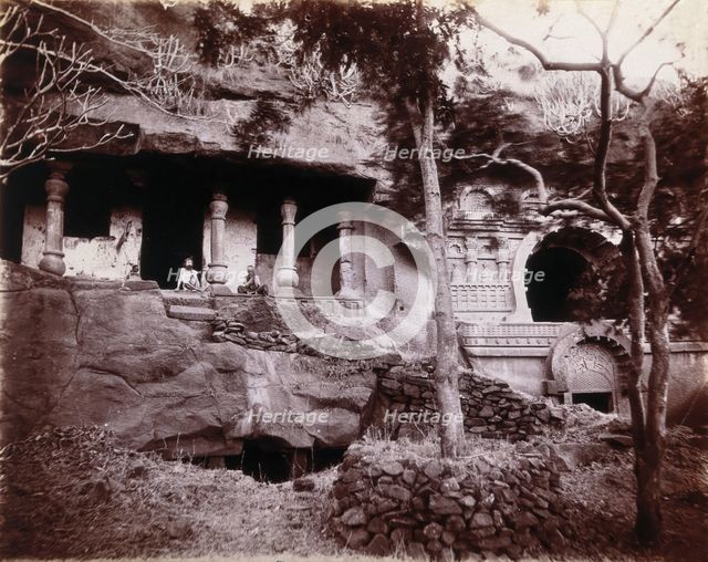 Two men sitting in a temple carved out of a rock face in Bombay at the time of the plague, 1896/1897 Creator: Unknown.