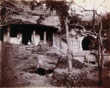 Two men sitting in a temple carved out of a rock face in Bombay at the time of the plague, 1896/1897 Creator: Unknown