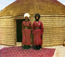 Two men standing on a rug, in front of yurt, between 1905 and 1915. Creator: Sergey Mikhaylovich Prokudin-Gorsky