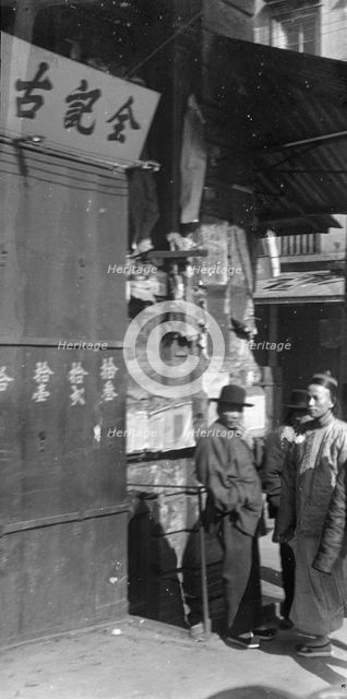 Two men standing on a sidewalk, Chinatown, San Francisco, between 1896 and 1906. Creator: Arnold Genthe.