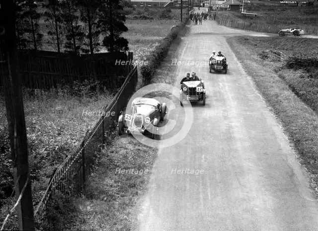 Two MG M types passing a broken down 1928 Alta Prototype, JCC Members Day, Brooklands, 4 July 1931. Artist: Bill Brunell.