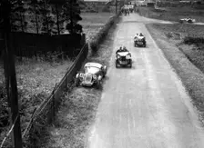 Two MG M types passing a broken down 1928 Alta Prototype, JCC Members Day, Brooklands, 4 July 1931. Artist: Bill Brunell