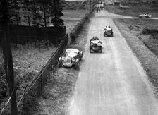 Two MG M types passing a broken down 1928 Alta Prototype, JCC Members Day, Brooklands, 4 July 1931. Artist: Bill Brunell