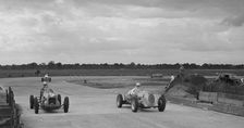 Two MGs racing at Brooklands, Surrey, c1930s. Artist: Bill Brunell