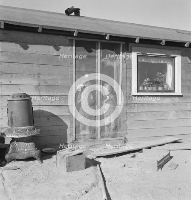 Two of the seven Browning children in doorway of their Oregon home, Dead Ox Flat, Oregon, 1939. Creator: Dorothea Lange.
