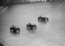 Two Austin 7s and an unidentified car racing at a BARC meeting, Brooklands, Surrey, 1931 Artist: Bill Brunell